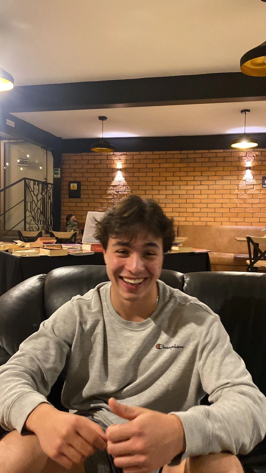 Smiling in a café, no reason needed