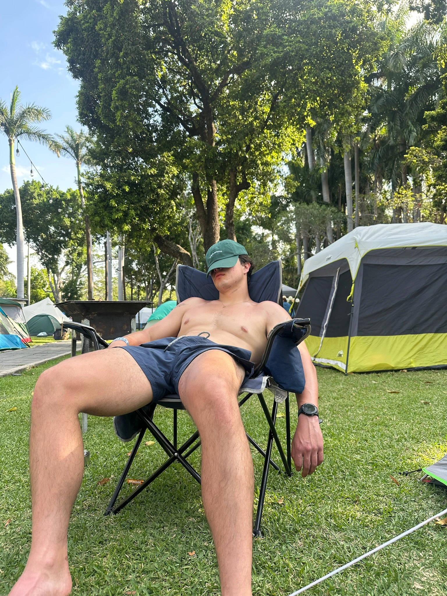 Resting at camp, hat over face, doing nothing