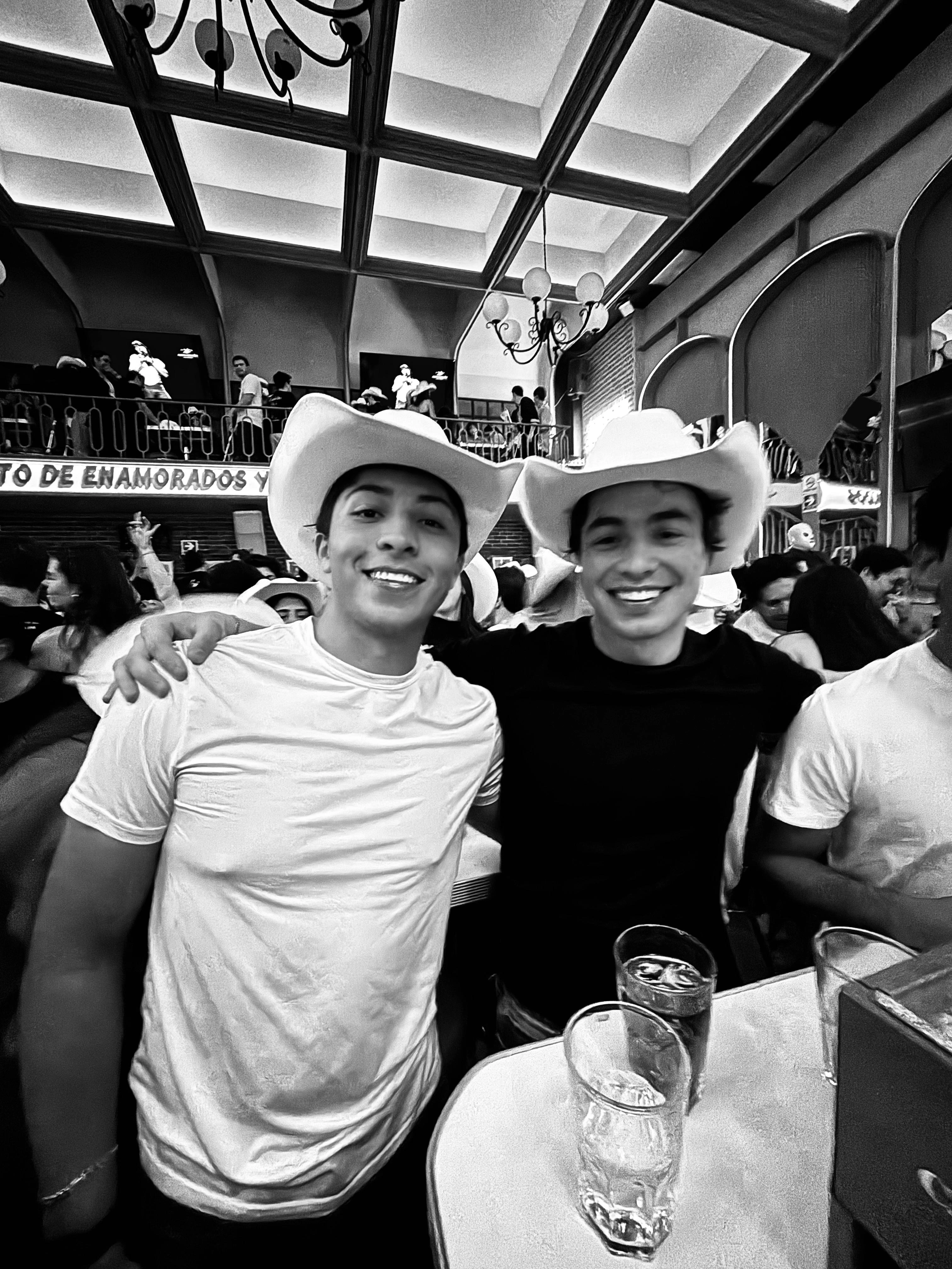 Friends in cowboy hats, laughing