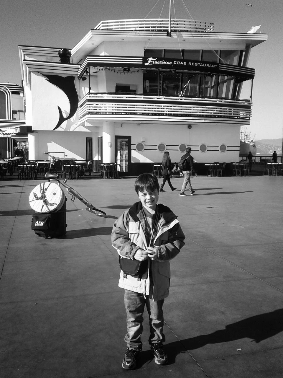 A kid standing at a pier, just being a kid